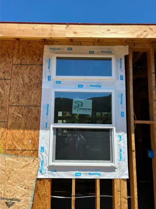 Close-up of a stacked window installed with Moistop PF flashing tape over OSB sheathing.