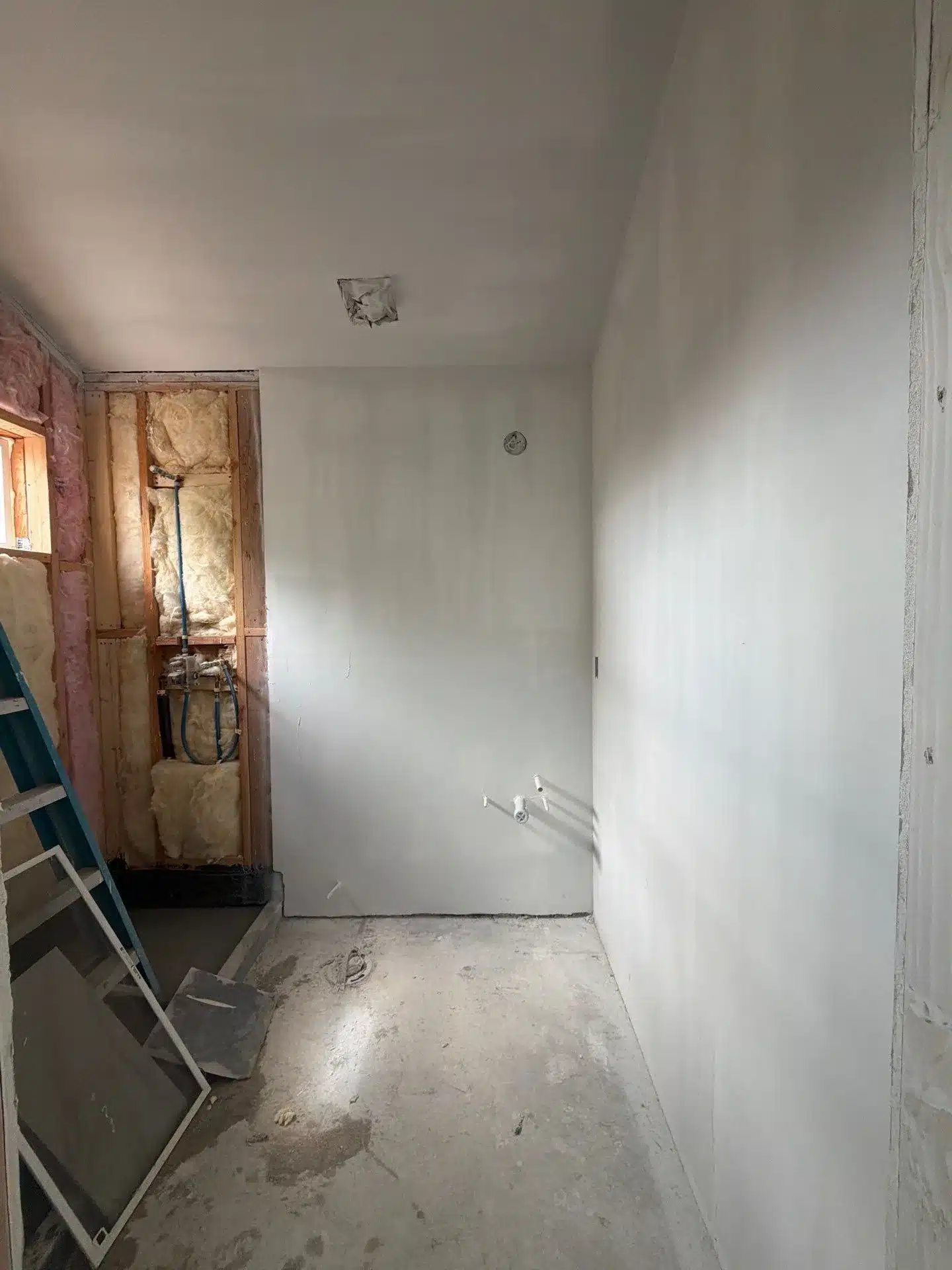 IBA Builders job site with exposed framing, insulation and plumbing rough-ins ready for city inspection